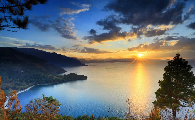 Lake Toba Tour Spectacle: Witnessing Sunrise Over the Lake